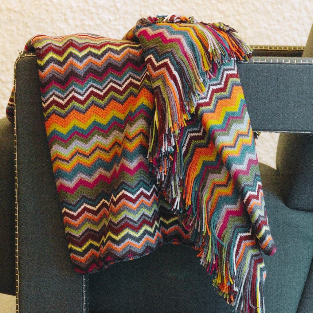Colourful bed throw on chair